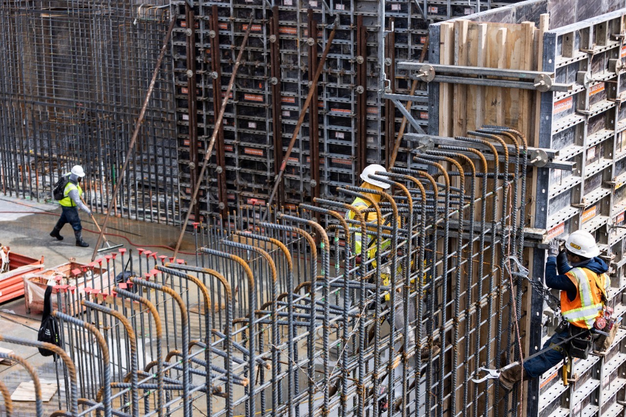 Contruction worker working on steel frame in early contricution of Blue Oval City facility